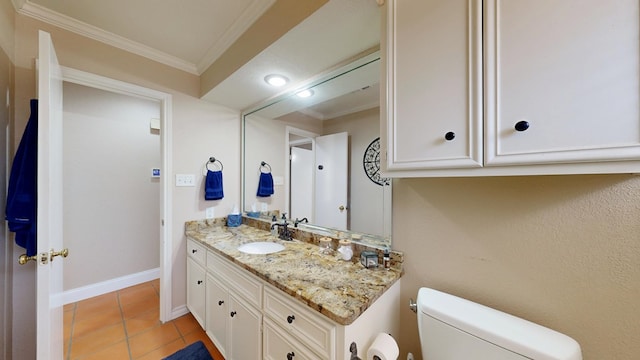 bathroom with baseboards, ornamental molding, toilet, vanity, and tile patterned flooring