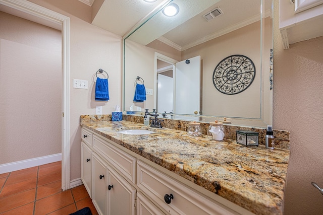 bathroom featuring visible vents, baseboards, ornamental molding, vanity, and tile patterned floors