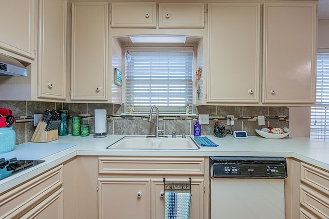 kitchen with a sink, backsplash, light countertops, and dishwasher