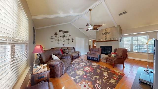 living area featuring tile patterned floors, a brick fireplace, a ceiling fan, and visible vents
