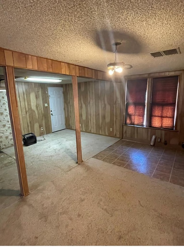 basement with carpet floors and a textured ceiling