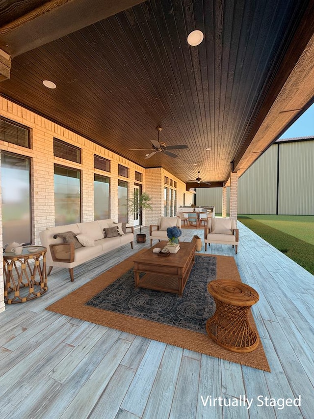 deck at dusk featuring ceiling fan and an outdoor living space