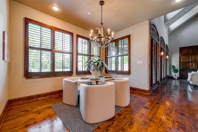 dining area featuring dark hardwood / wood-style flooring and an inviting chandelier