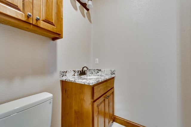 bathroom featuring toilet and vanity