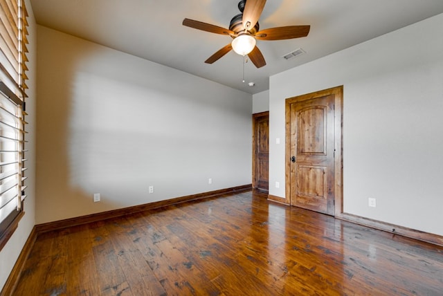 unfurnished bedroom featuring dark wood-type flooring and ceiling fan