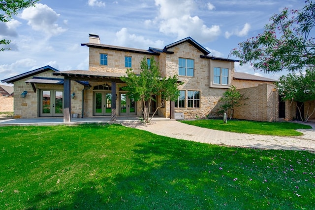 rear view of house featuring a patio area, french doors, and a yard