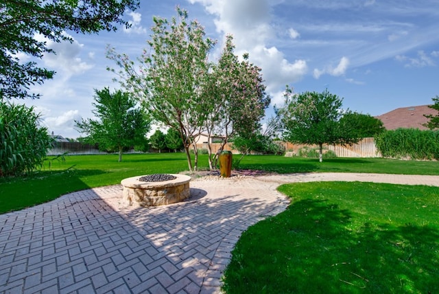 view of patio featuring a fire pit and a water view