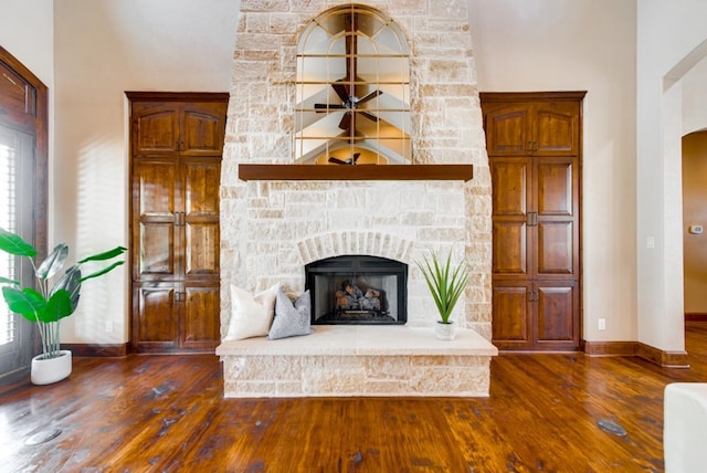 unfurnished living room featuring dark hardwood / wood-style flooring and a fireplace