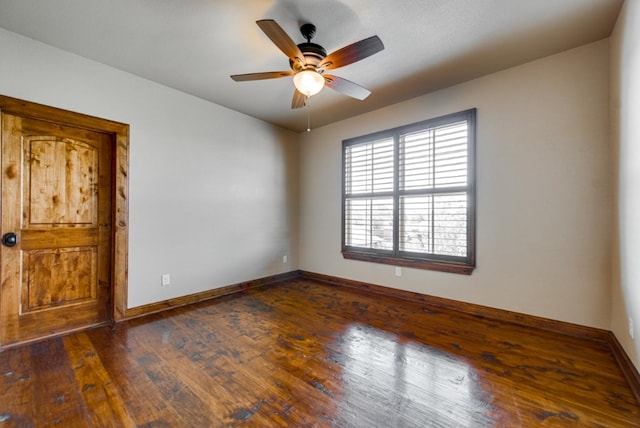 empty room with ceiling fan and dark hardwood / wood-style flooring