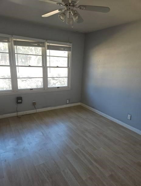 unfurnished room featuring hardwood / wood-style floors and ceiling fan