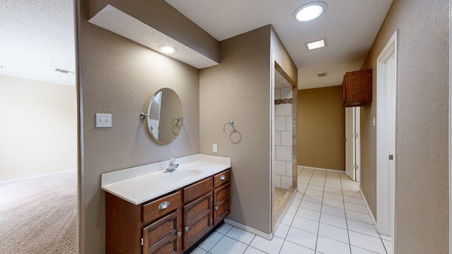 4203 Skyline Dr, Midland, TX 79707 - bathroom featuring vanity, tile patterned floors, a textured wall, and baseboards