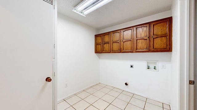 4203 Skyline Dr, Midland, TX 79707 - laundry room with cabinet space, electric dryer hookup, washer hookup, and light tile patterned flooring