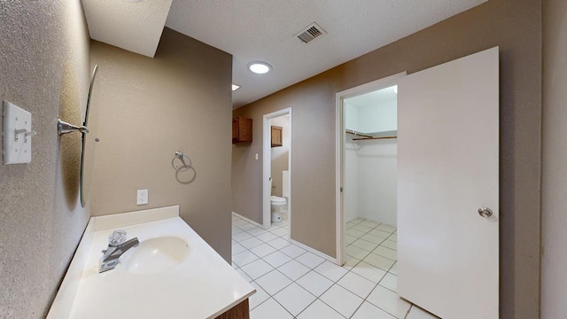 4203 Skyline Dr, Midland, TX 79707 - full bath featuring vanity, toilet, tile patterned flooring, and a walk in closet