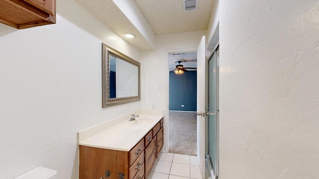4203 Skyline Dr, Midland, TX 79707 - bathroom with vanity, a textured wall, a ceiling fan, and tile patterned flooring