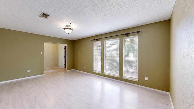 4203 Skyline Dr, Midland, TX 79707 - spare room featuring light wood-type flooring, a textured ceiling, and baseboards