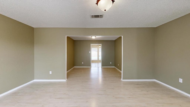 4203 Skyline Dr, Midland, TX 79707 - spare room with light wood-style floors, baseboards, and a textured ceiling