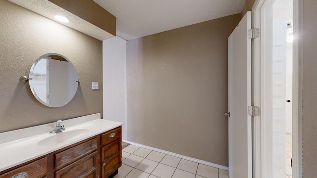 4203 Skyline Dr, Midland, TX 79707 - bathroom featuring vanity, tile patterned floors, and baseboards