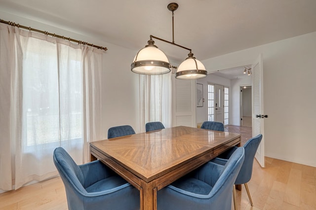 dining area featuring light wood-type flooring