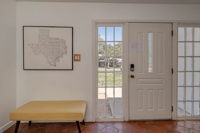 entryway featuring baseboards
