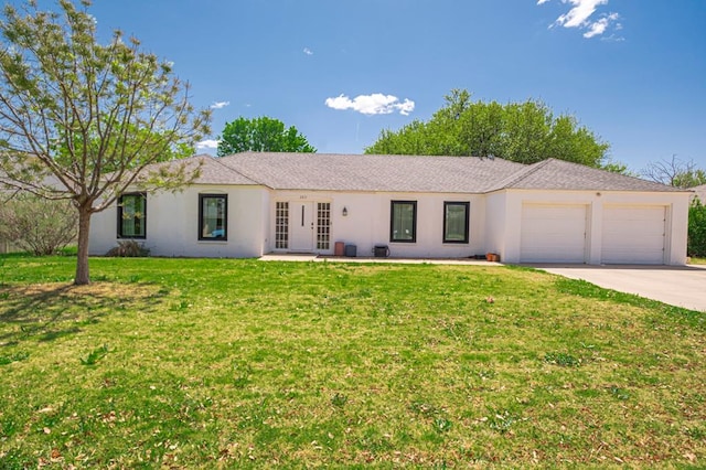 ranch-style home with an attached garage, a front lawn, stucco siding, and driveway