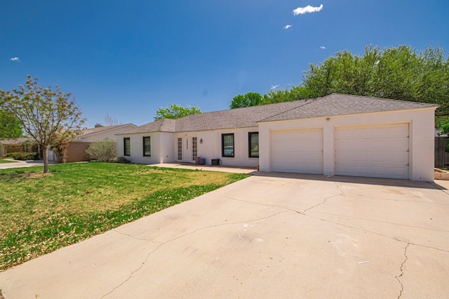 ranch-style house with stucco siding, an attached garage, driveway, and a front lawn