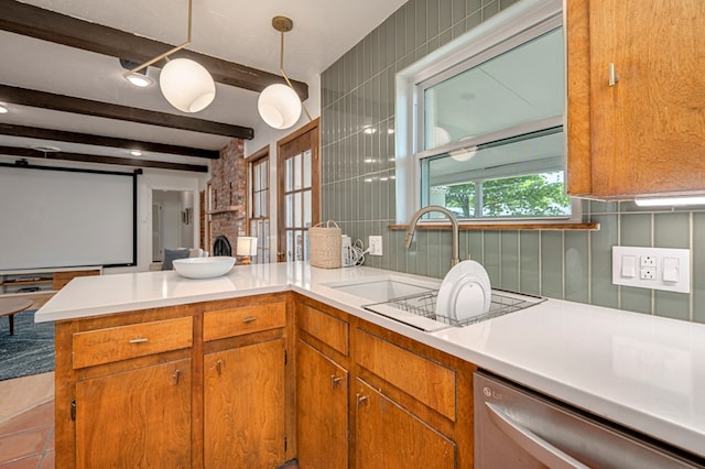 kitchen featuring brown cabinetry, a peninsula, beamed ceiling, light countertops, and dishwasher