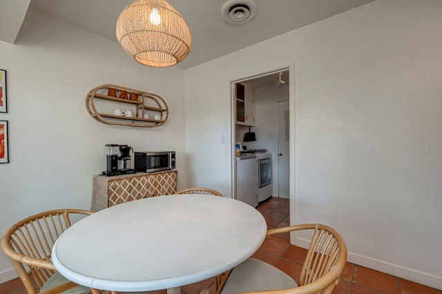 tiled dining area with baseboards and visible vents