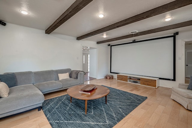 home theater with beamed ceiling and wood finished floors