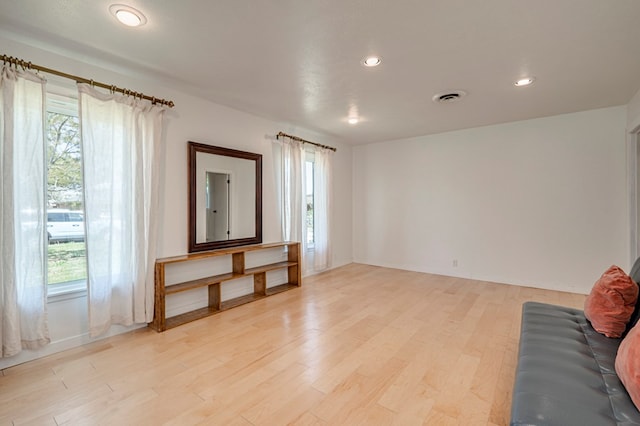 unfurnished living room with recessed lighting, light wood finished floors, and visible vents
