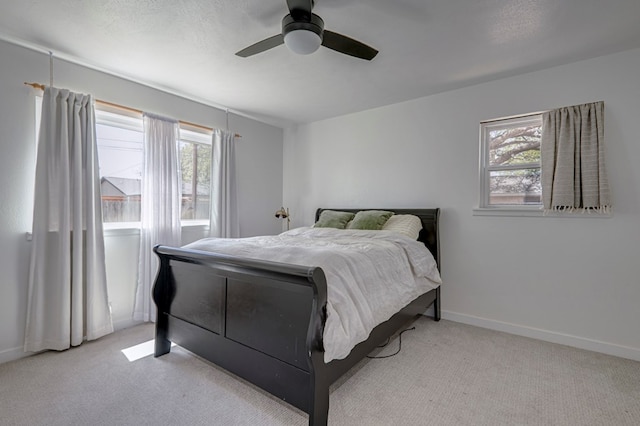 bedroom with carpet, ceiling fan, and multiple windows