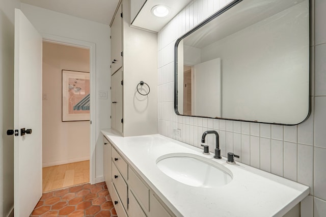 bathroom featuring vanity, backsplash, and tile patterned floors