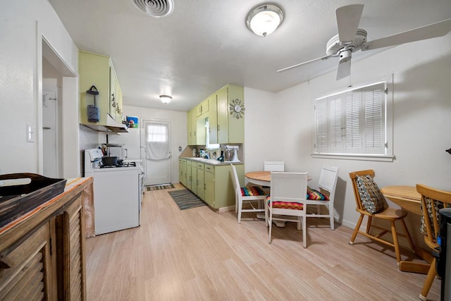 kitchen with green cabinets, ceiling fan, white range, and light wood-type flooring