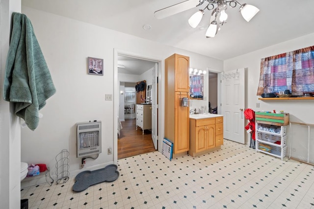 bathroom with vanity, ceiling fan, and heating unit