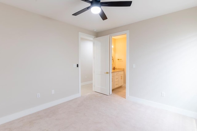 6407 W County Rd 41, Midland, TX 79707 - unfurnished bedroom featuring light carpet, baseboards, connected bathroom, and a ceiling fan