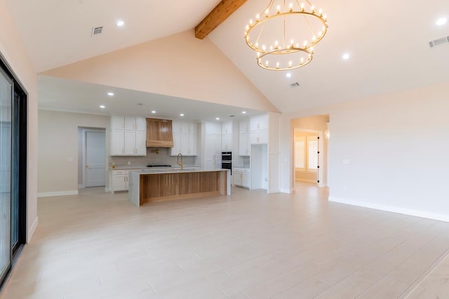 6407 W County Rd 41, Midland, TX 79707 - kitchen with a chandelier, high vaulted ceiling, open floor plan, beam ceiling, and baseboards