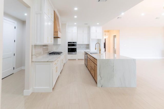 6407 W County Rd 41, Midland, TX 79707 - kitchen featuring a sink, appliances with stainless steel finishes, backsplash, a spacious island, and white cabinets