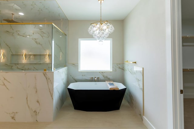 6407 W County Rd 41, Midland, TX 79707 - bathroom with a marble finish shower, a soaking tub, a walk in closet, and a sink