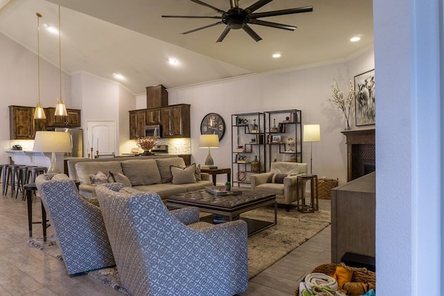 living room featuring light wood-type flooring, crown molding, ceiling fan, and lofted ceiling