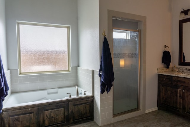 bathroom with vanity and separate shower and tub