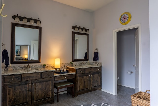 bathroom featuring hardwood / wood-style floors, vanity, and toilet