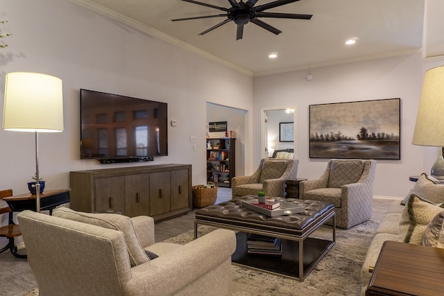 living room featuring light wood-type flooring, ceiling fan, and ornamental molding