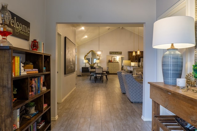 corridor featuring high vaulted ceiling and hardwood / wood-style flooring