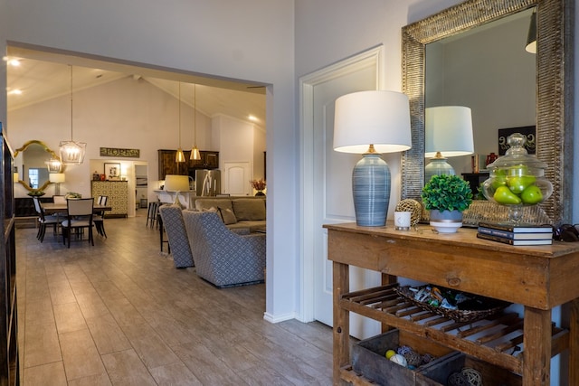 hall featuring high vaulted ceiling and hardwood / wood-style flooring