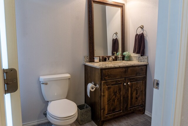 bathroom featuring vanity, toilet, and wood-type flooring