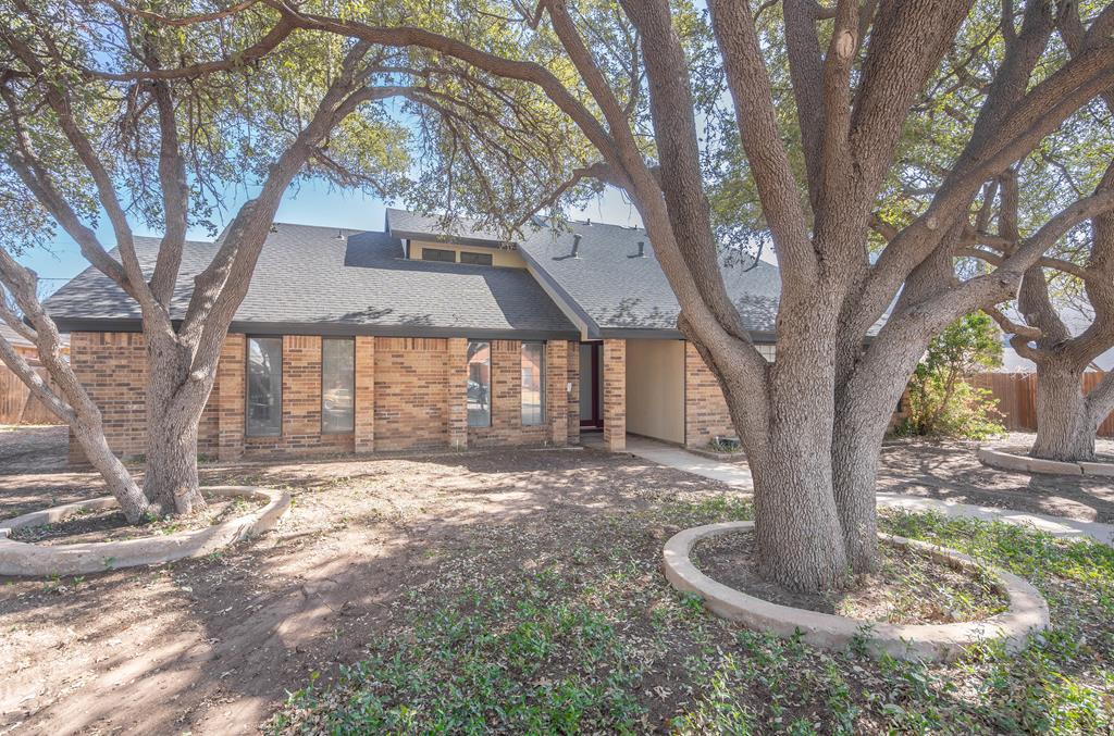 4404 Lennox Dr, Midland, TX 79702 - mid-century home featuring brick siding, fence, and roof with shingles
