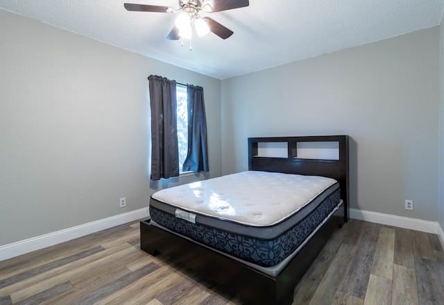 bedroom featuring hardwood / wood-style floors and ceiling fan