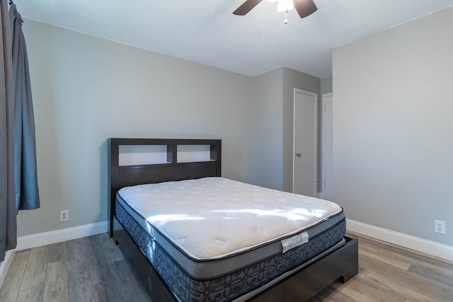 bedroom with hardwood / wood-style floors and ceiling fan