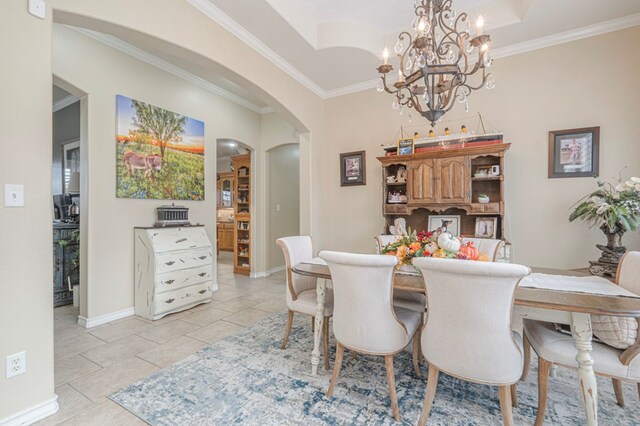 1900 Fringewood Dr, Midland, TX 79707 - dining room featuring arched walkways, a chandelier, baseboards, light tile patterned flooring, and crown molding