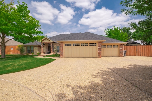 1900 Fringewood Dr, Midland, TX 79707 - ranch-style house featuring a front yard, a garage, brick siding, concrete driveway, and fence