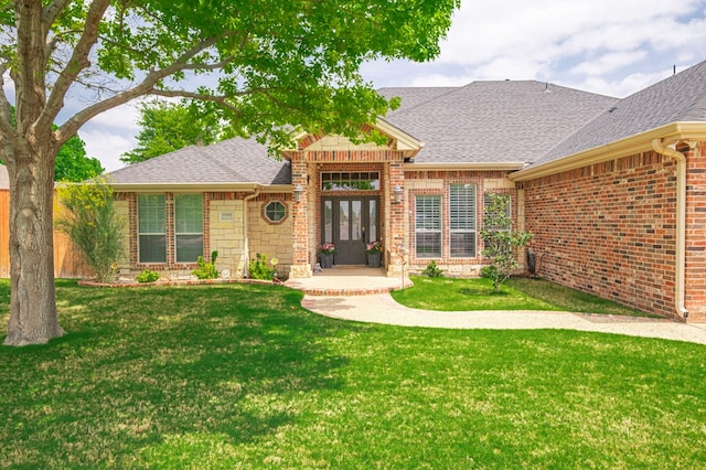 1900 Fringewood Dr, Midland, TX 79707 - view of front of house featuring brick siding, french doors, a shingled roof, and a front yard